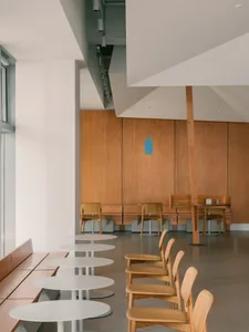 Empty restaurant interior with wooden tables and chairs, warm and inviting atmosphere