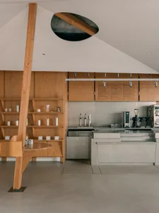 A well-equipped kitchen with wooden cabinets, two sinks, a refrigerator, and an oven, with a lived-in feel and warm atmosphere