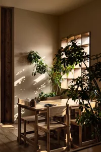Warm and inviting dining area with a wooden table, chairs, and a bowl possibly containing fruit