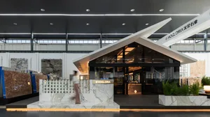 Elegant hotel lobby with marble countertop, large window, and two people in the scene