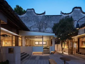 Inviting open space with stone walls, a staircase, and seating areas