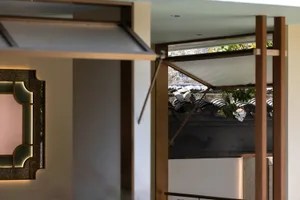 Open area with metal-framed windows, under-construction roof, and natural light