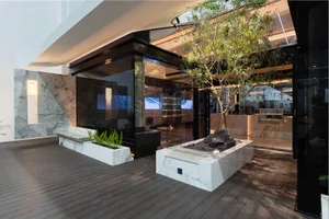 Inviting living area with natural light, potted plants, and two couches