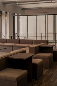 A spacious room with several couches in various positions, creating a calm and inviting atmosphere for relaxation and socializing