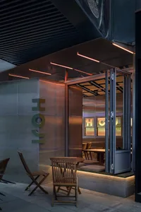 A cozy restaurant dining area with three chairs and two tables, creating an inviting atmosphere for a pleasant dining experience