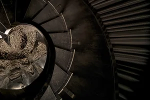 A black and white photo of a modern spiral staircase with a circular shape, creating a sense of depth and intrigue