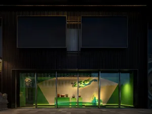 A museum-style interior with sculptures and vases on display, natural light from a large window, and bowls adding to the aesthetic appeal