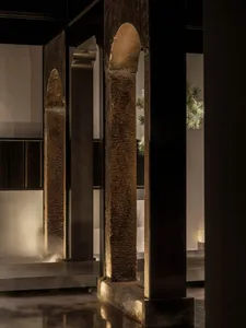 A dimly lit interior space with stone pillars and a mysterious atmosphere, inspired by ancient architecture