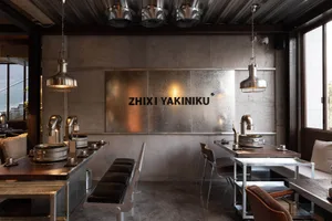 Modern dining space with gray walls, black chairs, and multiple tables, featuring various lighting fixtures throughout the space