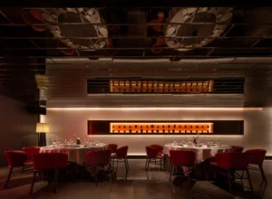 Sophisticated restaurant interior with wooden furniture, wine glasses, and a warm atmosphere
