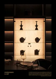 Dining area with a table, wine glasses, bowls, a cup, and decorative vases, set in a sophisticated interior design