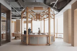 Sleek modern kitchen and dining space with a circular bar, wood flooring, and overhead lighting