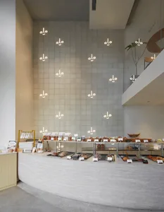 A bakery shop interior with a large display case filled with various pastries and an inviting atmosphere