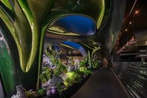 A restaurant with potted plants and vases, creating a warm and inviting atmosphere