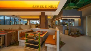 Inviting dining space with wooden tables, chairs, and bowls, set in a comfortable atmosphere