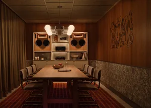 A warm and inviting kitchen dining area with a wooden theme, featuring a dining table, chairs, and natural light