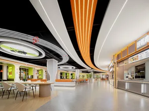 A bright and inviting open space with a high ceiling, modern design, and scattered chairs and dining tables, surrounded by potted plants