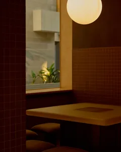 A dining table surrounded by two wooden chairs in a warm and inviting restaurant setting