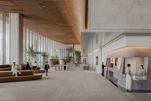 A large room with various seating options, potted plants, and people walking around, suggesting a space for socializing or gatherings