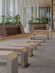 A public space with several wooden benches in various positions, creating a comfortable and inviting atmosphere for relaxation and socialization