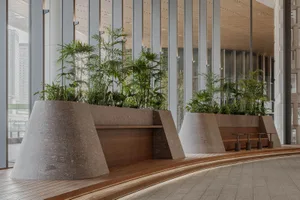 A modern interior space with multiple potted plants on the walls, creating a lush green atmosphere and adding depth to the space