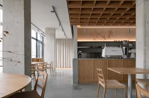 A spacious restaurant interior with multiple tables and chairs, creating an inviting atmosphere for guests