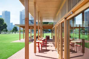 An outdoor dining area with wooden structures and furniture, creating a warm and inviting atmosphere for social gatherings or events