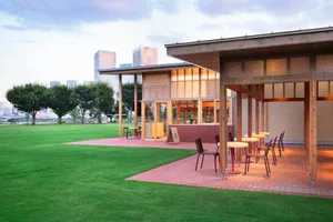An inviting outdoor restaurant with multiple dining tables and chairs, surrounded by a comfortable atmosphere perfect for meals