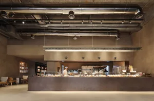 A bustling restaurant kitchen with people, food, and kitchen utensils, set against a background of kitchen equipment and storage