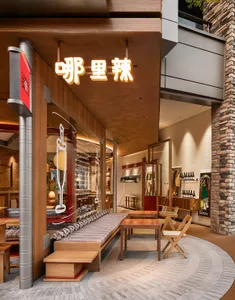 Modern Asian restaurant with a large dining area featuring tables, chairs, and wine glasses, creating an inviting atmosphere