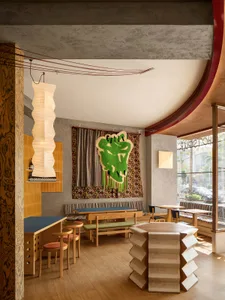 Warm and inviting restaurant interior with wooden floors and tables, comfortable seating, and a focus on creating a welcoming atmosphere