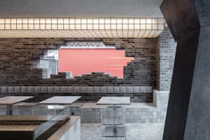 Cozy restaurant interior with brick walls, wooden tables, and comfortable seating