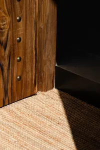 A dark room with a wooden door and carpeted floor, creating a cozy atmosphere