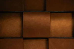 A high-quality leather wall with multiple panels, creating a warm and inviting atmosphere, possibly in a living area or library