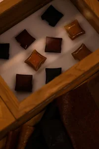 A wooden box filled with various colorful food items, including cakes and candies, arranged in an inviting and appetizing display