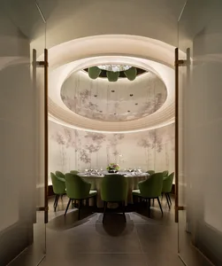 Elegant dining space with a round table, chairs, and wine glasses, set in a comfortable and inviting atmosphere