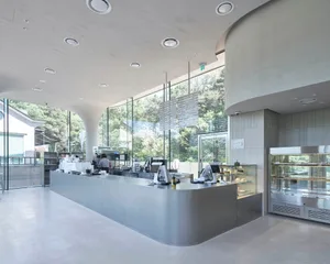 Casual open kitchen space with a large countertop, people present, and inviting atmosphere