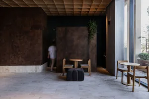 A modern showroom with a large brown table and chairs, surrounded by suitcases, creating a stylish and inviting atmosphere