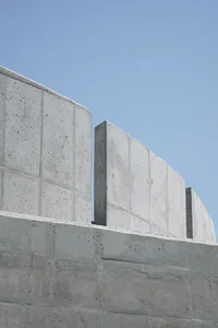 A modern building with concrete walls and a cement structure, featuring a minimalist and functional design