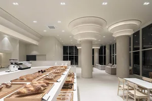 Inviting kitchen space with a wooden counter, white walls, and warm lighting