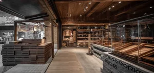 A warm and inviting bakery shop with wooden floors and walls, displaying various products and items on different surfaces
