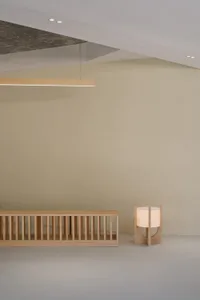 Empty minimalist living space with a wooden bench and two side lights