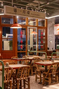 Warm and inviting Asian restaurant interior with wooden tables and chairs, traditional design elements, and a cozy atmosphere