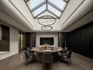 An inviting dining space with a large table, fireplace, and comfortable atmosphere
