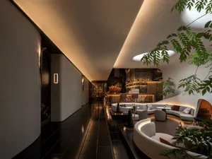 Upscale lounge area with curved design, modern furniture, and potted plants, creating a sophisticated and inviting atmosphere