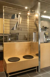 Modern kitchen with two sinks on a wooden countertop, featuring two toilets and a functional design