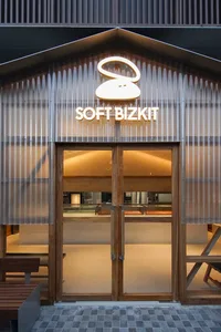 Casual restaurant interior with two empty dining tables, wooden floor, and inviting atmosphere