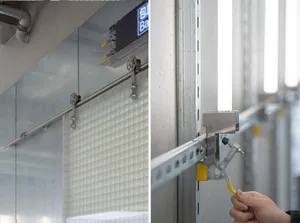 Bathroom with glass walls, metal rack, and metal wall, featuring a combination of glass and metal elements in a well-lit space