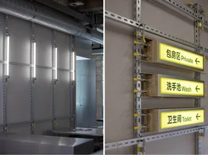 A modern industrial space with a gray metal wall, a pipe system, and a functional aesthetic