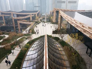 A modern building with a central courtyard, featuring multiple levels and clean lines, illuminated by natural light through windows
